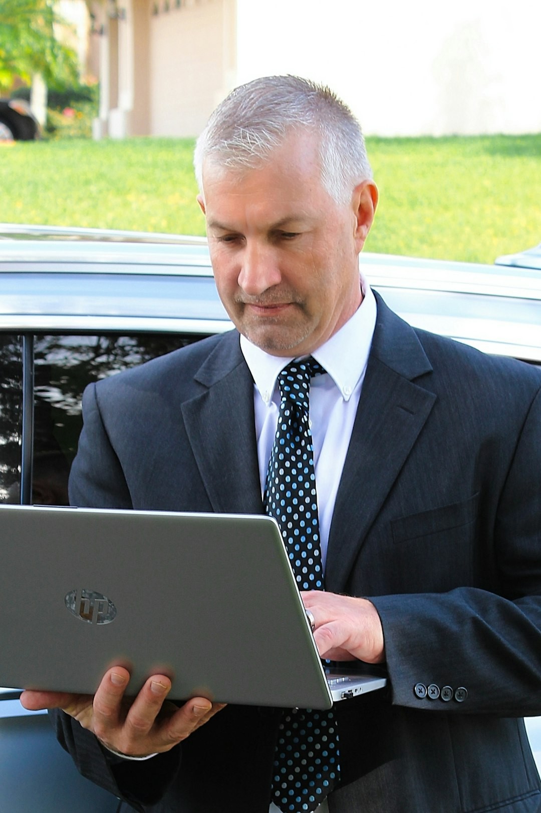 a man in a suit holding a tablet